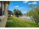 Lush backyard overlooking a lake, featuring a screened-in patio at 529 Quail Down Dr, Debary, FL 32713