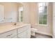 Bathroom features a single sink vanity with gray tile flooring and natural lighting at 529 Quail Down Dr, Debary, FL 32713