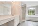 Bathroom displays a large vanity, tiled shower, and soaking tub under a window at 529 Quail Down Dr, Debary, FL 32713