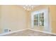 Cozy dining room featuring decorative chandelier, large window, and ceramic tile flooring at 529 Quail Down Dr, Debary, FL 32713