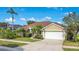 Beautifully landscaped single-story home with lush green lawn and a two car garage at 529 Quail Down Dr, Debary, FL 32713