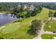 Scenic aerial view of a well-maintained golf course with a pond and lush greenery at 529 Quail Down Dr, Debary, FL 32713