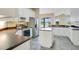 Spacious kitchen with stainless steel appliances, white cabinets, and eat-in island at 529 Quail Down Dr, Debary, FL 32713