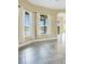 Cozy living room with large windows offering serene lake views and neutral colors at 529 Quail Down Dr, Debary, FL 32713