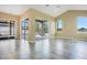 Open-concept living room with tile floors and access to lanai with pool and pond views at 529 Quail Down Dr, Debary, FL 32713