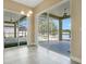 Sunroom with stunning lake and pool views through sliding glass doors and tile floors at 529 Quail Down Dr, Debary, FL 32713