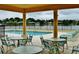 Inviting pool area with ample seating, tables, and a serene lake view, perfect for outdoor relaxation and entertaining at 529 Quail Down Dr, Debary, FL 32713