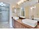 Modern bathroom featuring dual vessel sinks, wood cabinets and walk-in shower at 530 E Central Blvd # 406, Orlando, FL 32801