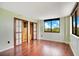 A bright bedroom with hardwood floors, natural light, and built in custom closet at 530 E Central Blvd # 406, Orlando, FL 32801