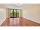Bright living room with hardwood floors and sliding glass doors to a private balcony at 530 E Central Blvd # 406, Orlando, FL 32801