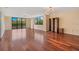 An open living room with hardwood floors, many windows, and decorative lighting fixtures at 530 E Central Blvd # 406, Orlando, FL 32801