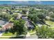 An aerial view showcases a home in lush surroundings, complete with solar panels for eco-friendly living at 533 Pickfair Ter, Lake Mary, FL 32746