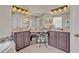 Double vanity bathroom featuring framed mirrors, tiled floors, and a makeup vanity at 533 Pickfair Ter, Lake Mary, FL 32746