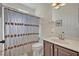 Neutral bathroom featuring vanity with cabinet, toilet, and shower with decorative curtain at 533 Pickfair Ter, Lake Mary, FL 32746