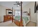 Bedroom with decorative four poster bed frame, ceiling fan, and carpet floors at 533 Pickfair Ter, Lake Mary, FL 32746