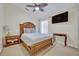 Cozy bedroom featuring a wood bed frame, ceiling fan, and carpet flooring at 533 Pickfair Ter, Lake Mary, FL 32746
