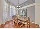 Elegant dining room featuring a wooden table, chandelier, and an open layout with hardwood flooring at 533 Pickfair Ter, Lake Mary, FL 32746