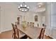 Elegant dining room featuring a wooden table, chandelier, and an open layout with hardwood flooring at 533 Pickfair Ter, Lake Mary, FL 32746