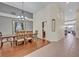 Elegant dining room featuring a wooden table, chandelier, and an open layout with hardwood flooring at 533 Pickfair Ter, Lake Mary, FL 32746