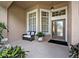 Inviting front porch with seating area and decorative plants, offering a warm welcome at 533 Pickfair Ter, Lake Mary, FL 32746