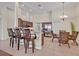 Bright kitchen with a large island, stainless steel appliances, and dining table with wicker chairs at 533 Pickfair Ter, Lake Mary, FL 32746