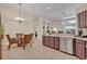 Spacious kitchen and dining area with tile flooring, stainless appliances, and nearby living room at 533 Pickfair Ter, Lake Mary, FL 32746