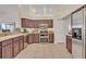 Bright kitchen featuring tile floors, stainless steel appliances, and ample cabinet space at 533 Pickfair Ter, Lake Mary, FL 32746
