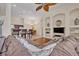 A comfortable living room with a large sectional, built-in shelving, and an open view to the kitchen at 533 Pickfair Ter, Lake Mary, FL 32746