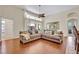 Cozy living room with hardwood floors, neutral tones, and lots of natural light from large windows at 533 Pickfair Ter, Lake Mary, FL 32746