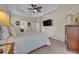 Bright main bedroom featuring neutral walls, carpet floors, ceiling fan, and a television at 533 Pickfair Ter, Lake Mary, FL 32746