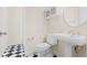 Bathroom showcasing black and white checkerboard floors and a pedestal sink at 548 S Hyer Ave # 1, Orlando, FL 32801