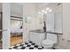 Bathroom showcasing checkerboard floors and a vanity with doorway view to bedroom at 548 S Hyer Ave # 1, Orlando, FL 32801