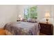 Comfortable bedroom with a floral quilt and two matching lamps and lush views at 548 S Hyer Ave # 1, Orlando, FL 32801