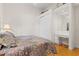 Bedroom showcasing a floral quilt and a built in desk and vanity area with ample storage at 548 S Hyer Ave # 1, Orlando, FL 32801