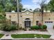 Charming exterior showcasing a well-maintained building with an arched entry and meticulous landscaping at 548 S Hyer Ave # 1, Orlando, FL 32801