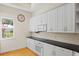 Bright kitchen boasts white cabinetry, black countertops, and lots of natural light at 548 S Hyer Ave # 1, Orlando, FL 32801