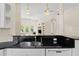 Open kitchen with breakfast bar, granite counters, white cabinets and stainless steel appliances at 548 S Hyer Ave # 1, Orlando, FL 32801