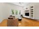 Bright living room featuring three windows, a modern ceiling fan, and a custom entertainment center at 548 S Hyer Ave # 1, Orlando, FL 32801