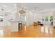 Spacious living room and kitchen with hardwood floors, white cabinets and modern lighting at 548 S Hyer Ave # 1, Orlando, FL 32801