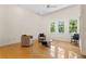 Sunlit living room boasting a ceiling fan, tall windows, and hardwood floors at 548 S Hyer Ave # 1, Orlando, FL 32801