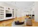 Open-concept living room with gleaming wood floors, high ceilings, and an arched doorway to the dining area at 548 S Hyer Ave # 1, Orlando, FL 32801