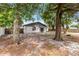 Spacious backyard with mature trees providing ample shade at 558 Tyler Ave, Deltona, FL 32725
