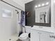 Bathroom featuring a walk-in shower, a white single sink vanity, and modern fixtures at 558 Tyler Ave, Deltona, FL 32725