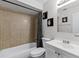 Bathroom with a tub, single sink vanity, and neutral tile at 558 Tyler Ave, Deltona, FL 32725