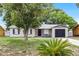 Charming single-story home features a stone-accented entrance and a lush, green lawn at 558 Tyler Ave, Deltona, FL 32725