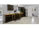 Modern kitchen with dark cabinetry, butcher block countertops, and stainless steel appliances at 558 Tyler Ave, Deltona, FL 32725