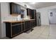 Charming kitchen featuring modern black cabinets, light wood countertops, and stainless steel appliances at 558 Tyler Ave, Deltona, FL 32725