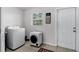 Bright laundry room with modern washer and dryer units, and tile flooring at 558 Tyler Ave, Deltona, FL 32725