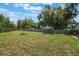 Large grassy backyard enclosed by a wooden fence, providing ample space at 704 Tangerine Ct, Winter Garden, FL 34787