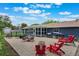 Backyard features a large patio with multiple seating areas and a storage shed with luscious green grass at 704 Tangerine Ct, Winter Garden, FL 34787